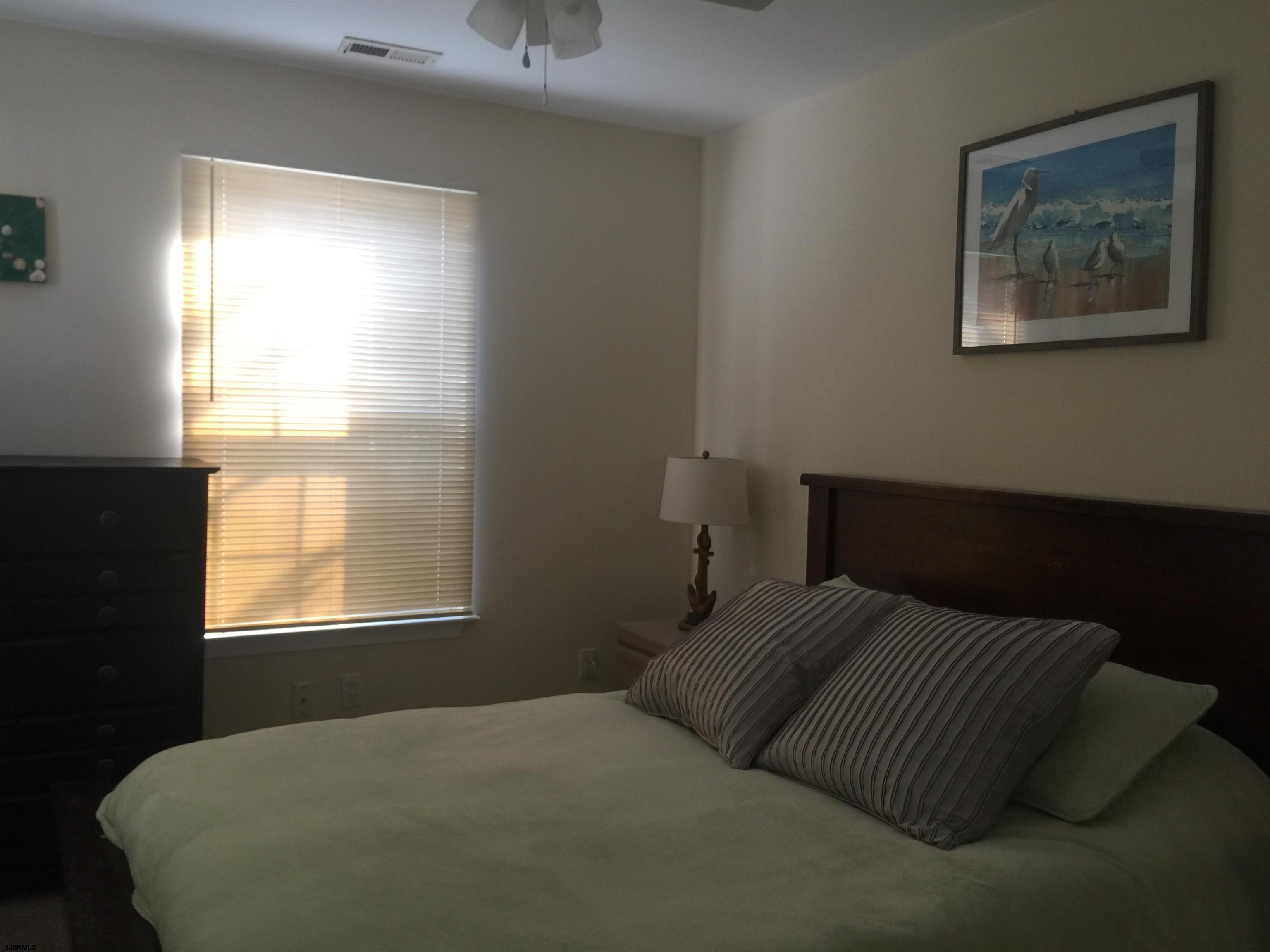 4013 West Brigantine Avenue, Unit 1 Brigantine, NJ 08203 - Photo 18 of 33 a bedroom with a bed and a window