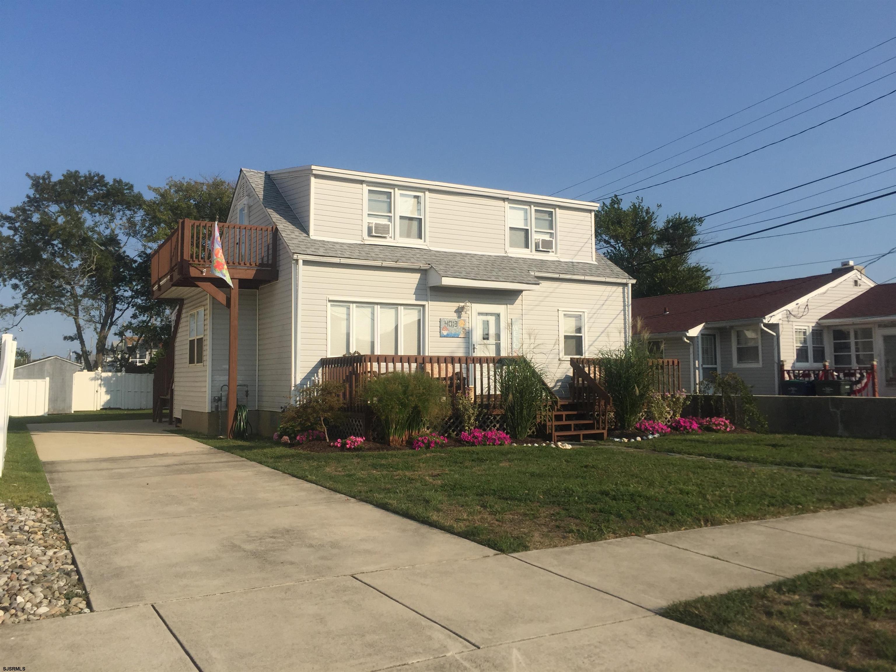 4013 West Brigantine Avenue, Unit 1 Brigantine, NJ 08203 - Photo 2 of 33 a front view of a house with a yard