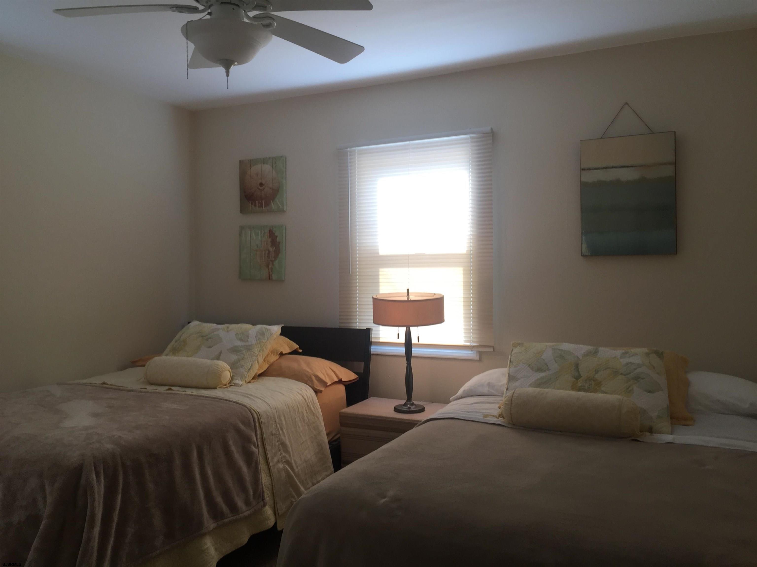 4013 West Brigantine Avenue, Unit 1 Brigantine, NJ 08203 - Photo 21 of 33 a bedroom with two beds and a night stand