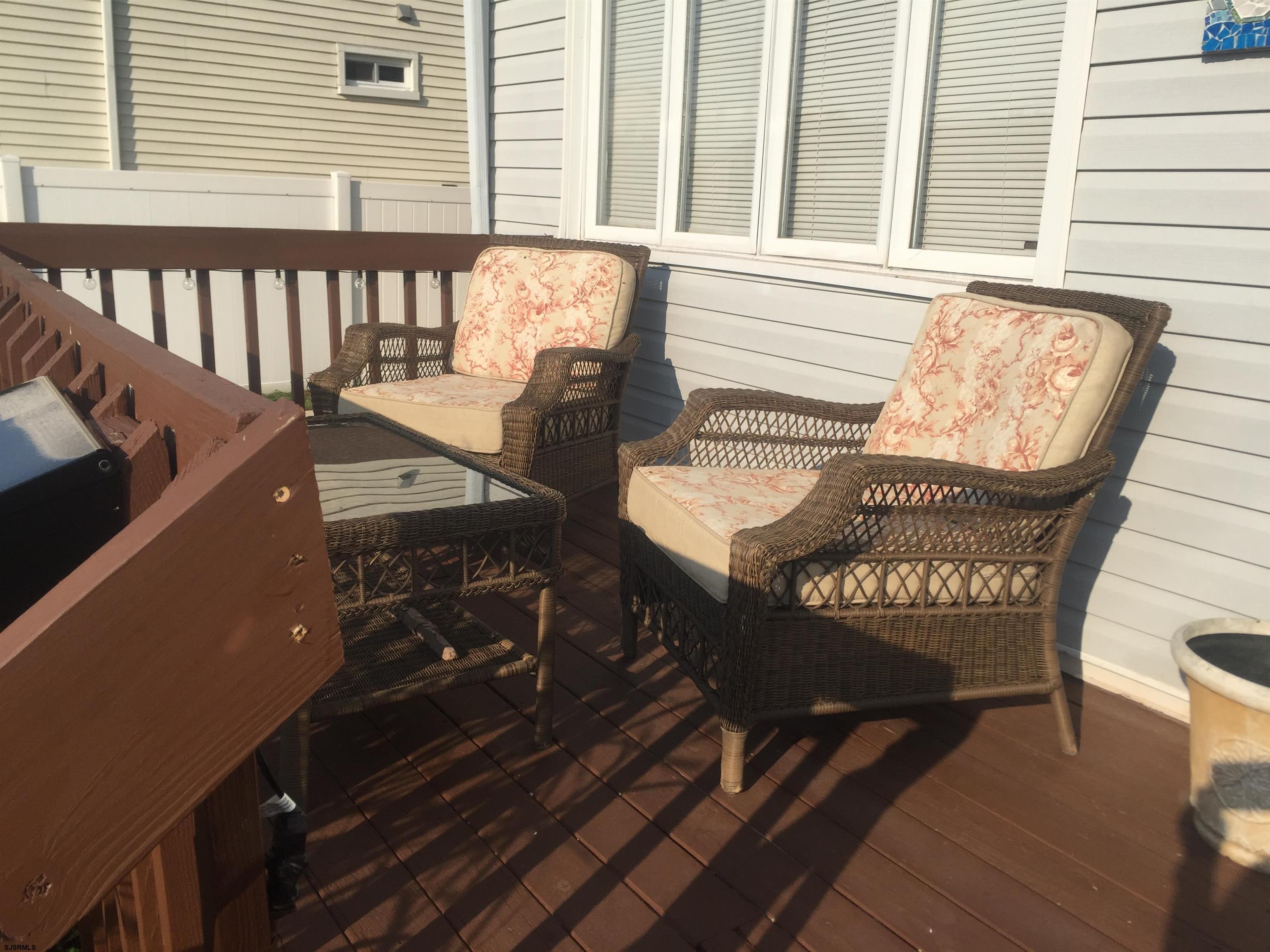 4013 West Brigantine Avenue, Unit 1 Brigantine, NJ 08203 - Photo 3 of 33 a view of a chairs and a table on the deck