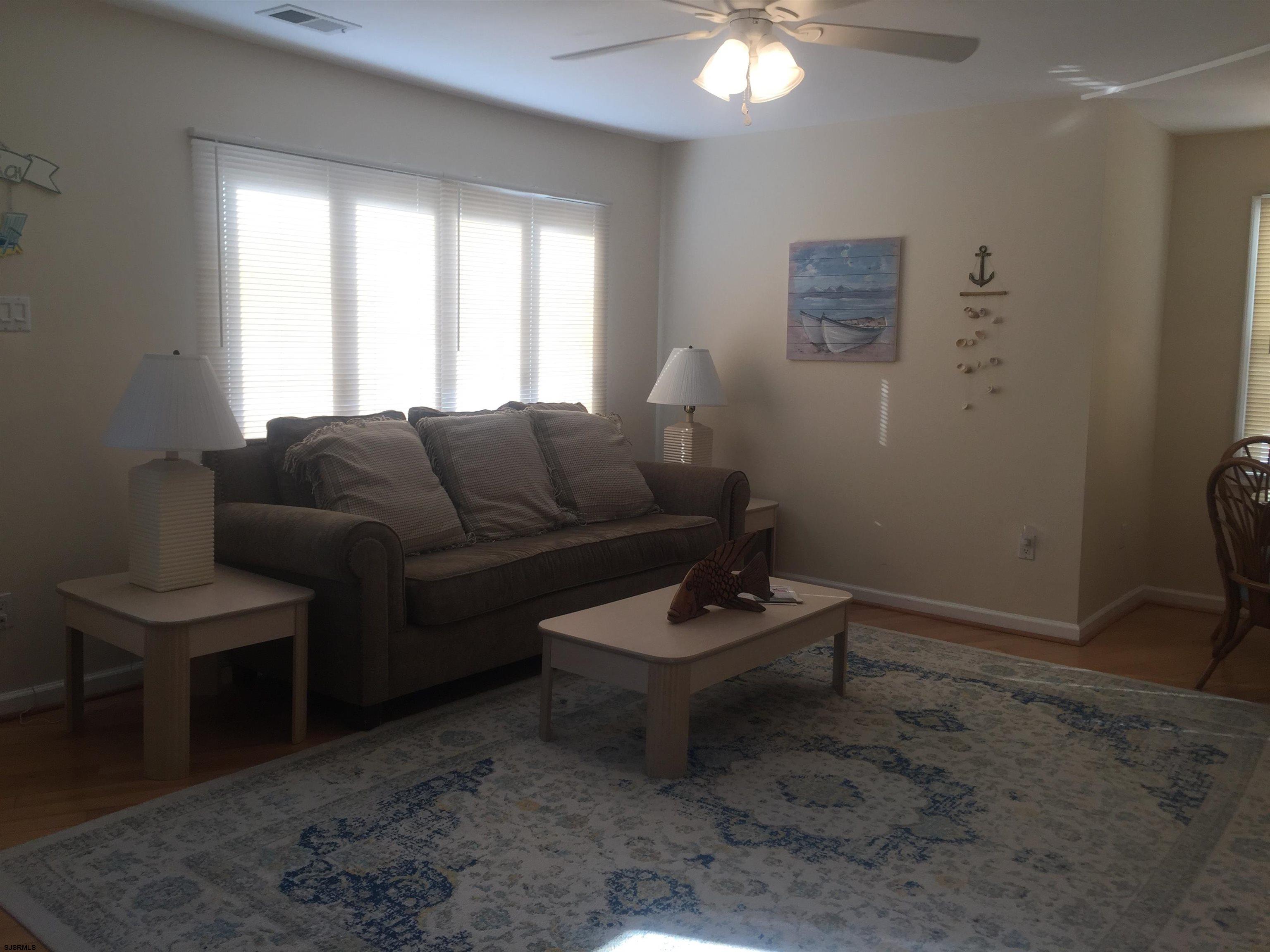4013 West Brigantine Avenue, Unit 1 Brigantine, NJ 08203 - Photo 8 of 33 a living room with furniture a couch and a window