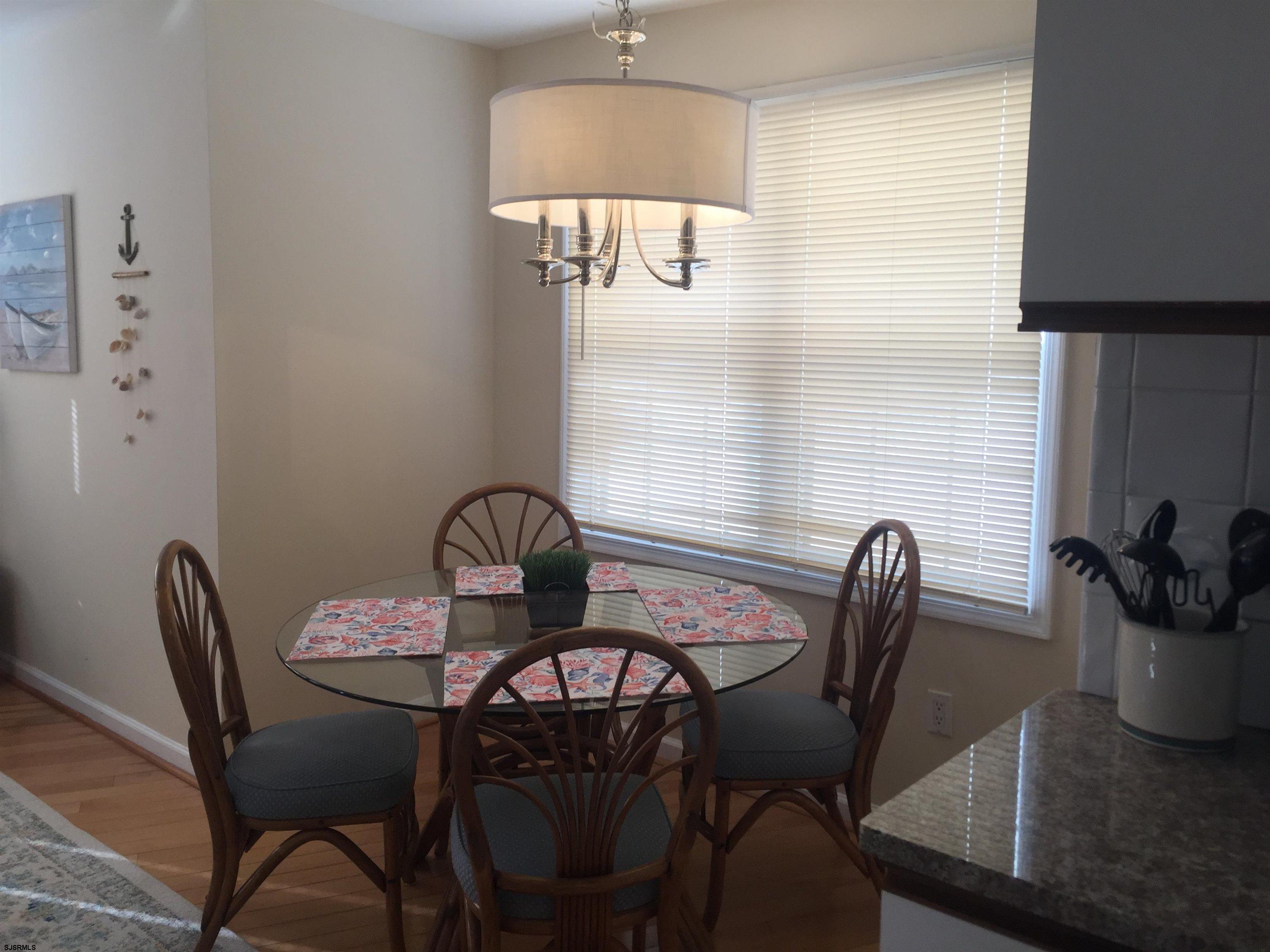 4013 West Brigantine Avenue, Unit 1 Brigantine, NJ 08203 - Photo 10 of 33 a view of a dining room with furniture and wooden floor
