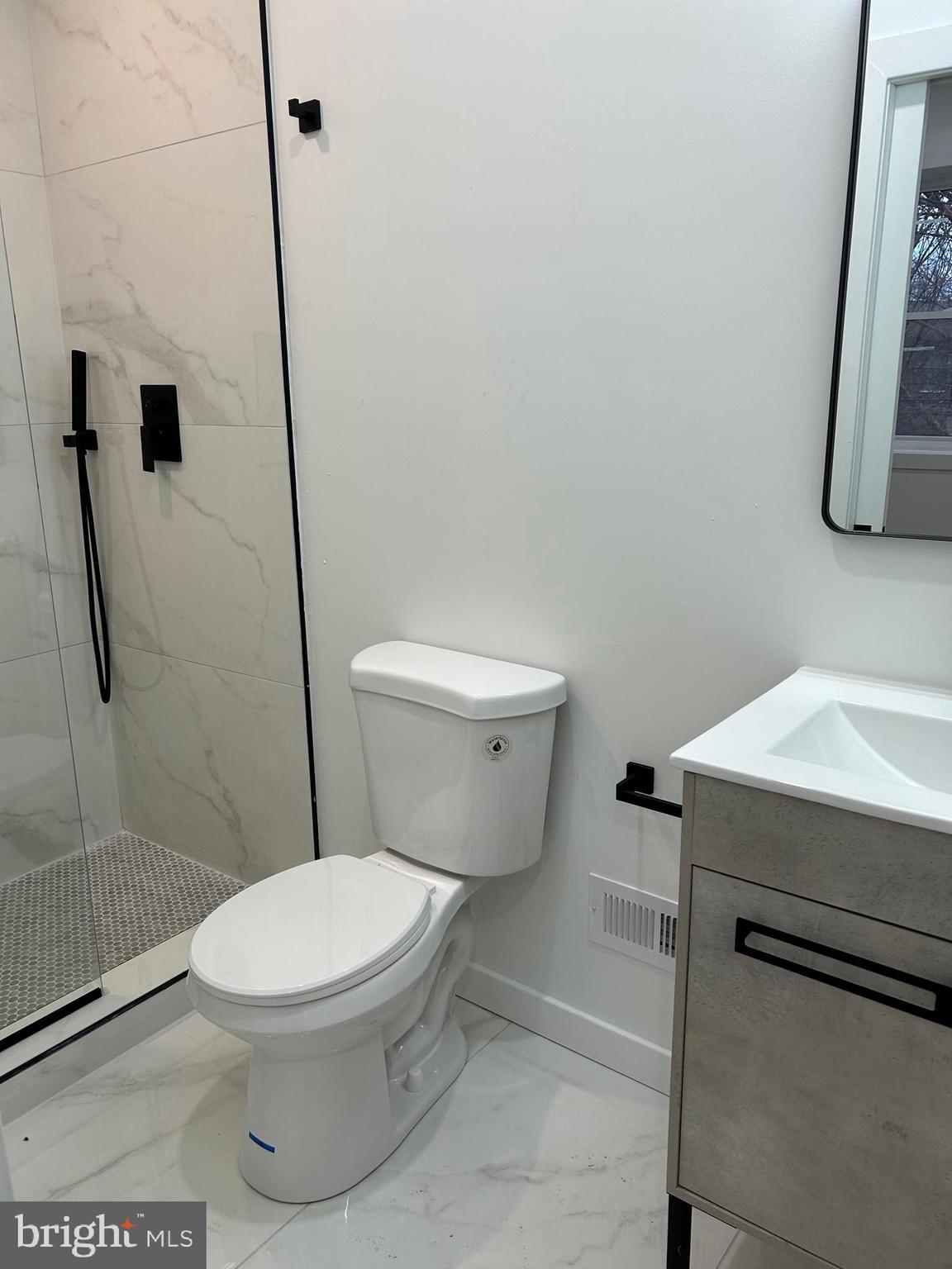 1163 Gerritt Street Philadelphia, PA 19147 - Photo 9 of 11 a white toilet sitting next to a bathroom sink