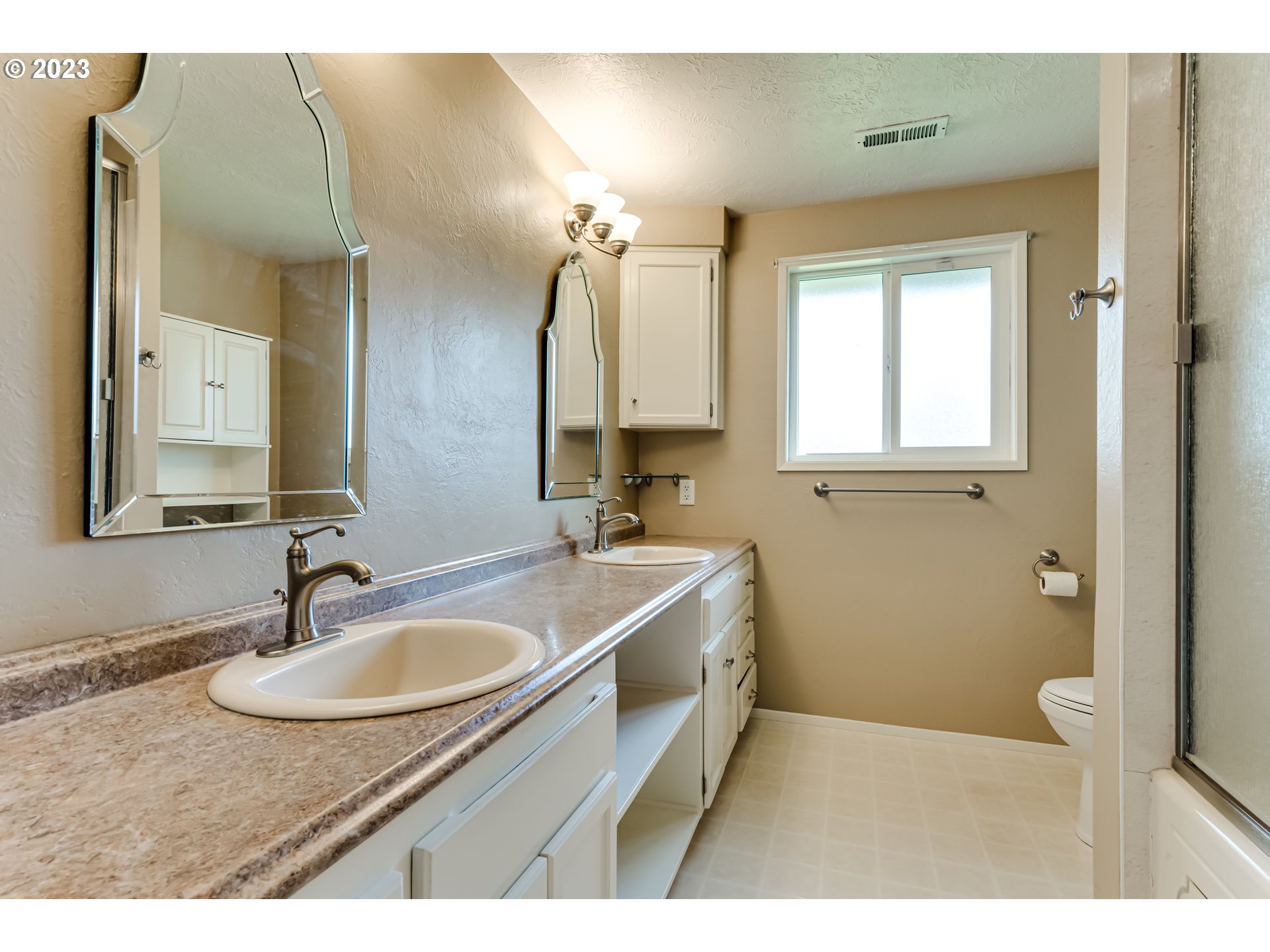 2407 17th Street Springfield, OR 97477 - Photo 12 of 40 a bathroom with a sink double vanity granite and a mirror