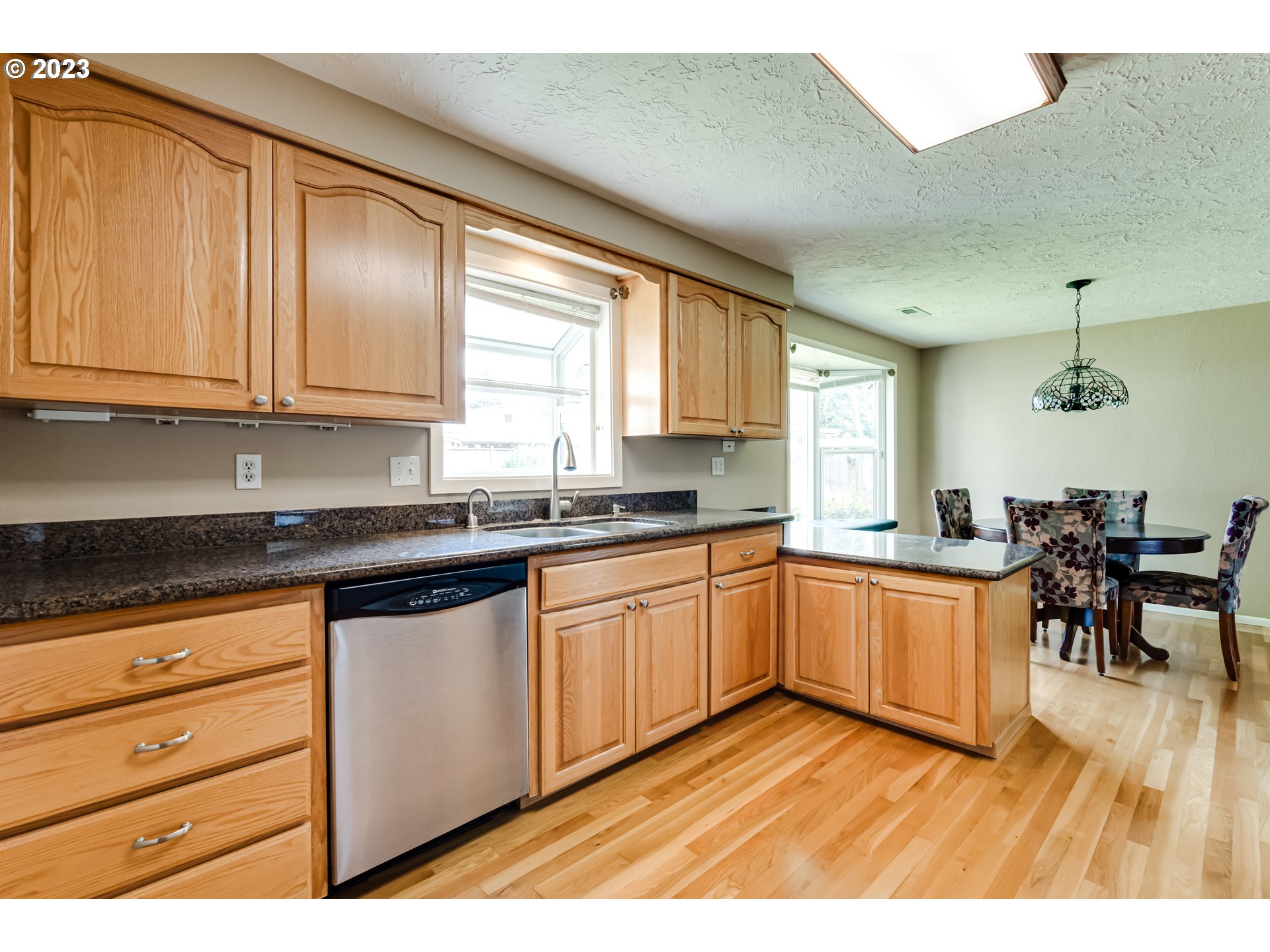 2407 17th Street Springfield, OR 97477 - Photo 20 of 40 a kitchen with stainless steel appliances granite countertop a stove a sink and a microwave