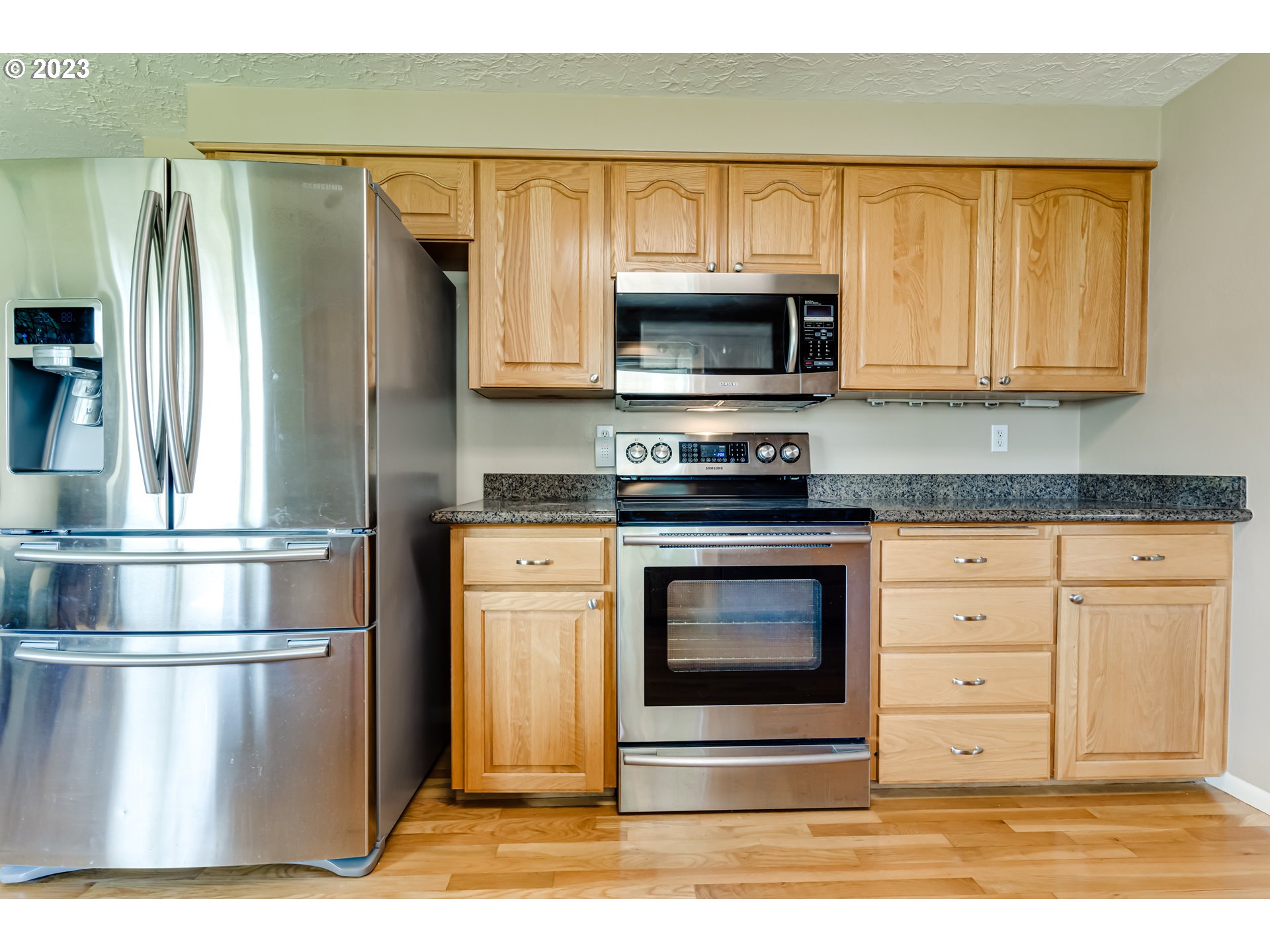 2407 17th Street Springfield, OR 97477 - Photo 21 of 40 a kitchen with stainless steel appliances granite countertop a refrigerator stove and microwave