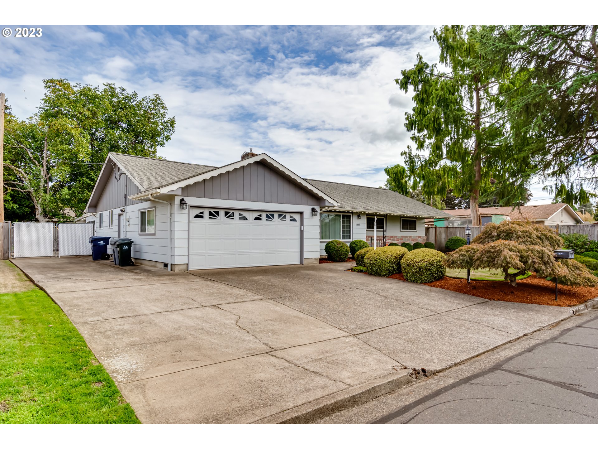 2407 17th Street Springfield, OR 97477 - Photo 4 of 40 a front view of a house with a yard and garage