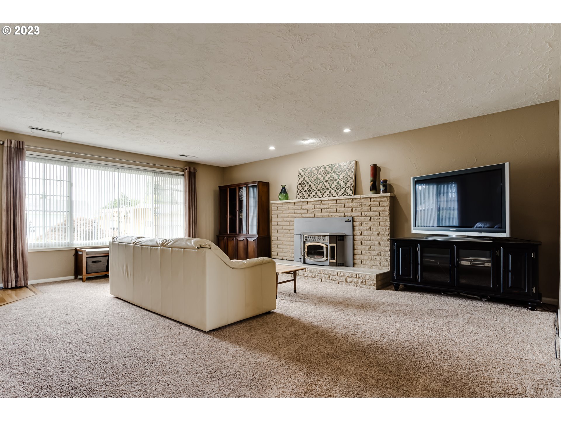 2407 17th Street Springfield, OR 97477 - Photo 5 of 40 a living room with furniture a flat screen tv and a fireplace