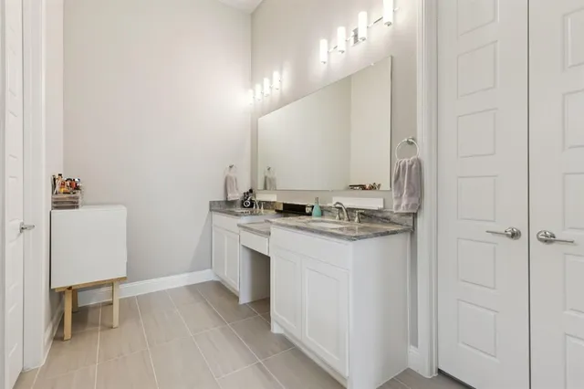 a bathroom with a sink a toilet a mirror and vanity