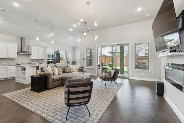 a living room kitchen with furniture and a large window