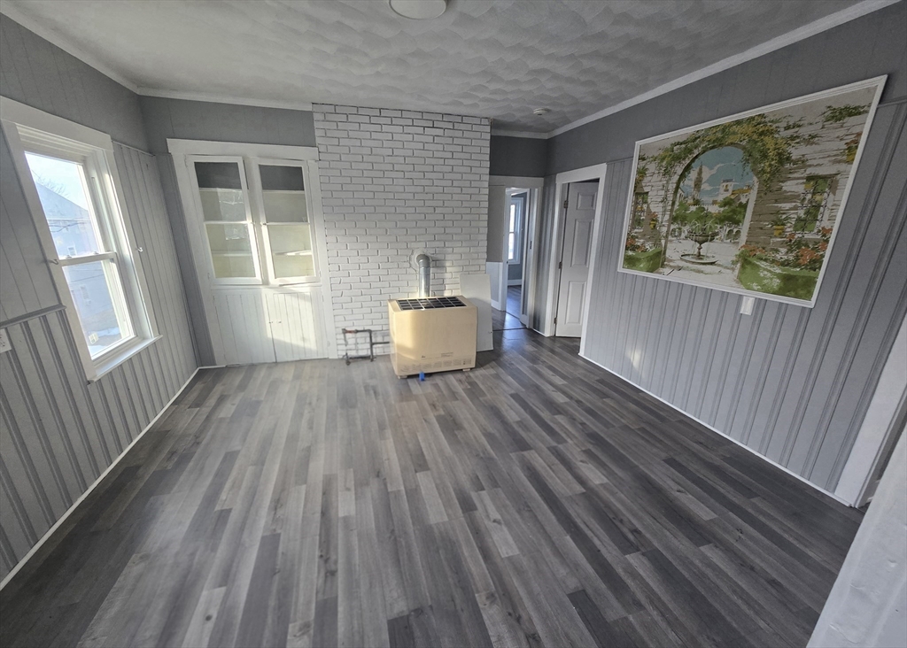 351 Tecumseh Street, Unit 2 Fall River, MA 02721 - Photo 1 of 14 a living room with wooden floor and a rug