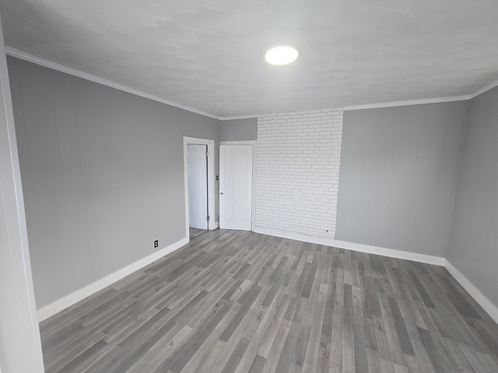 351 Tecumseh Street, Unit 2 Fall River, MA 02721 - Photo 11 of 14 a view of an empty room and wooden floor