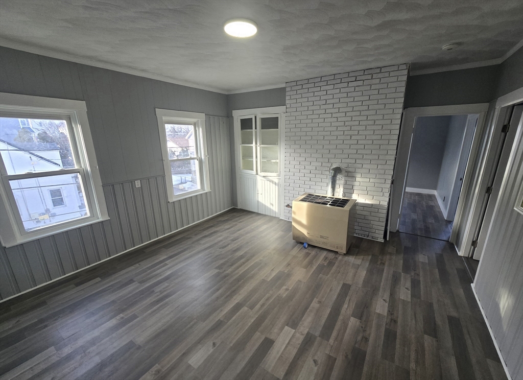 351 Tecumseh Street, Unit 2 Fall River, MA 02721 - Photo 14 of 14 a living room with a bed and large window