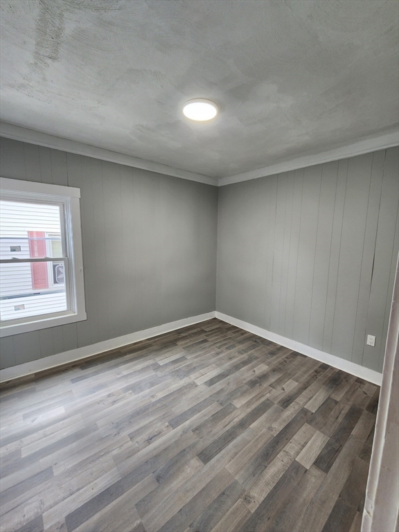 351 Tecumseh Street, Unit 2 Fall River, MA 02721 - Photo 4 of 14 a view of empty room with wooden floor