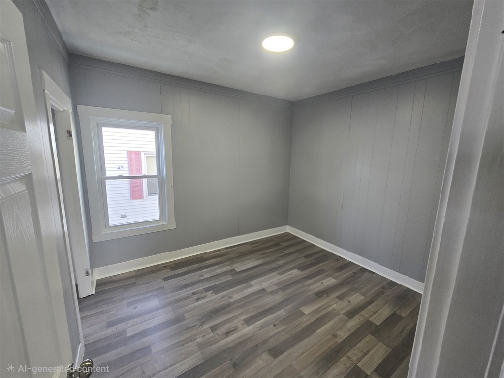 351 Tecumseh Street, Unit 2 Fall River, MA 02721 - Photo 10 of 14 an empty room with wooden floor and windows
