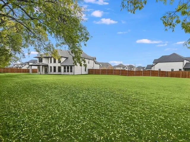 a view of building with garden and trees