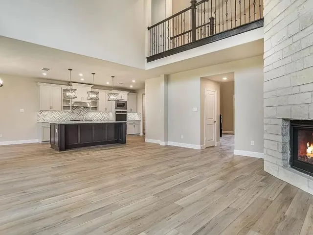 a view of kitchen with kitchen island wooden floor and ceiling fan