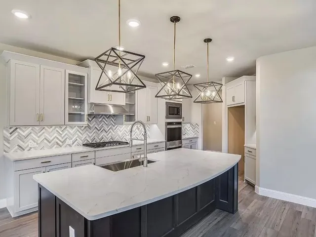 a kitchen with kitchen island a sink appliances and wooden floor