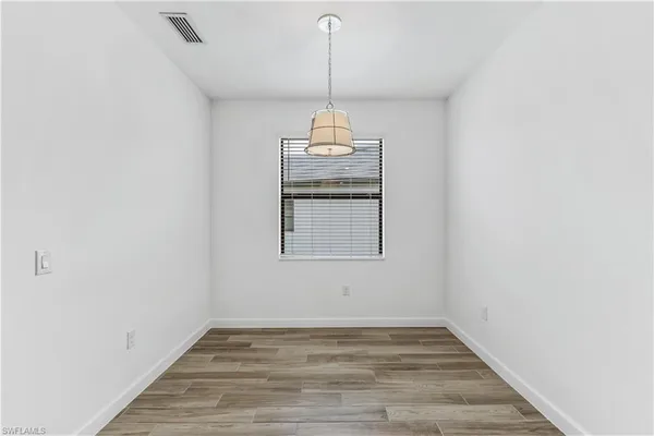 a view of a room with wooden floor wooden floor and windows