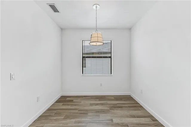 a view of a room with wooden floor wooden floor and windows