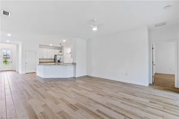 a view of kitchen view wooden floor and kitchen