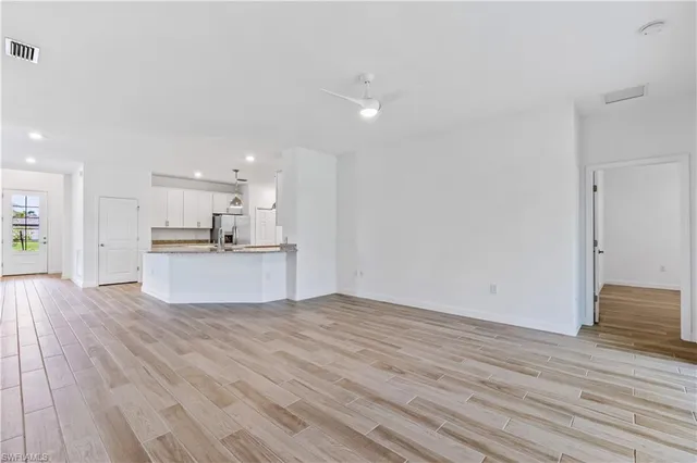 a view of kitchen view wooden floor and kitchen