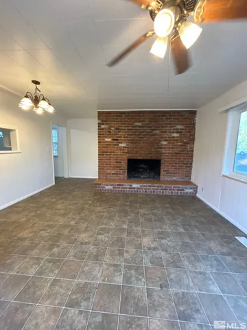 a view of empty room with a fireplace