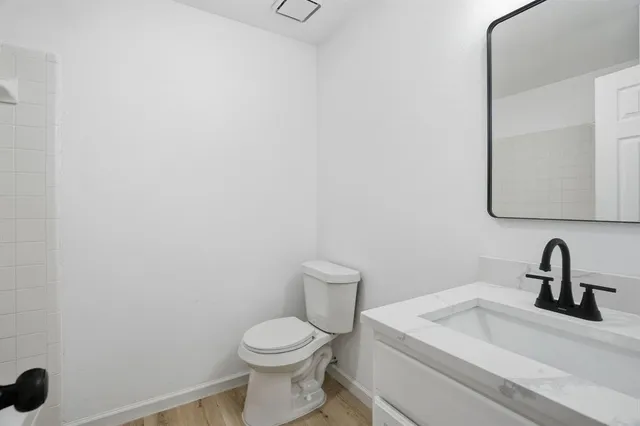 a bathroom with a sink a toilet and mirror