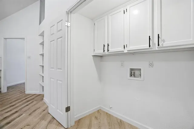 a view of a closet with wooden floor