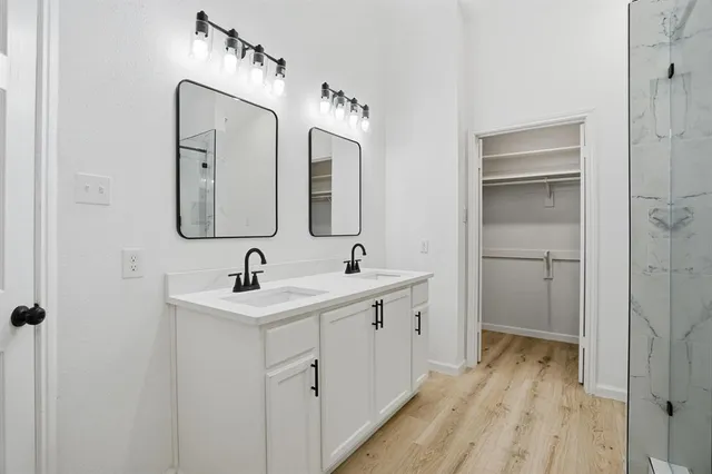 a bathroom with a double vanity sink and mirror
