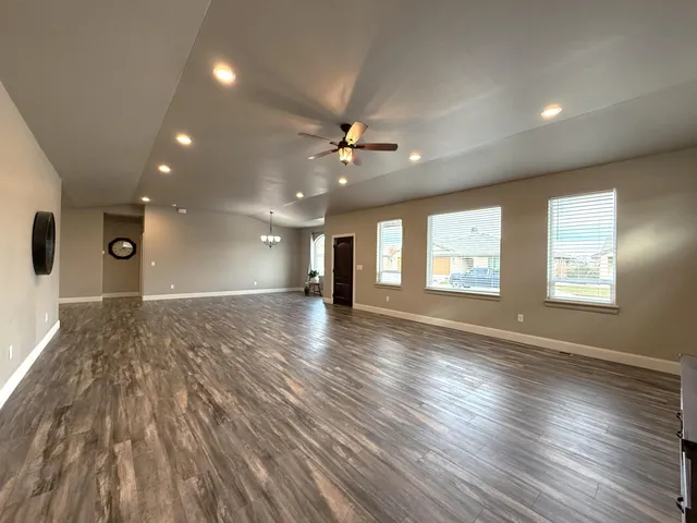 a view of a room with wooden floor and potted plant