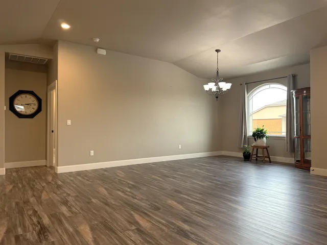 a kitchen with stainless steel appliances granite countertop a kitchen island hardwood floor sink stove dining table and chairs