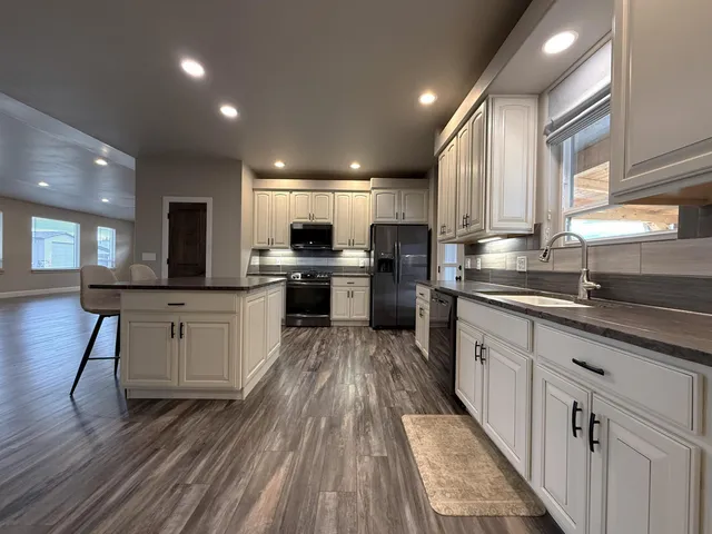 a spacious bedroom with a bed and a ceiling fan