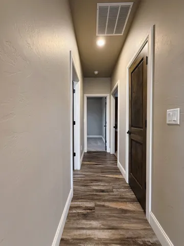 an empty room with closet and a ceiling fan