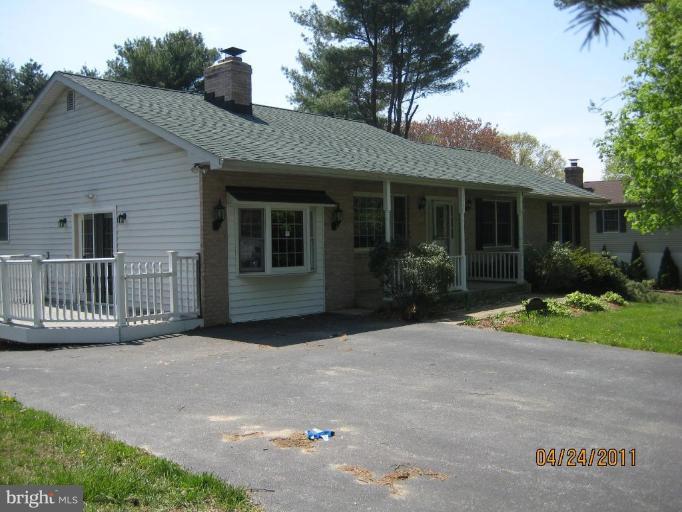 10005 German Road Ellicott City, MD 21042 - Photo 3 of 20 a view of a house with a yard and potted plants