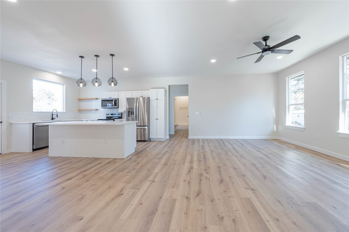 11541 Main Street Jonestown, TX 78645 - Photo 7 of 15 a view of a kitchen with a sink cabinets and wooden floor