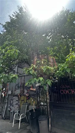 a view of a chairs and table in backyard