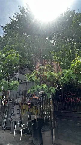 a view of a chairs and table in backyard