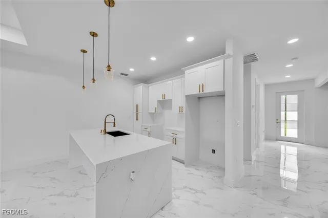 a view of a kitchen with a sink and a refrigerator