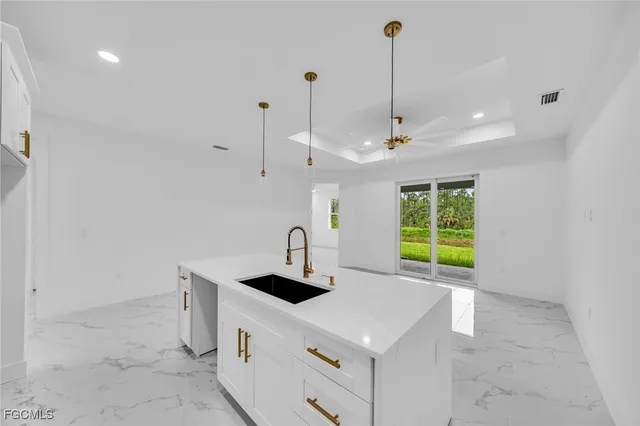 a kitchen with a sink a stove and a refrigerator