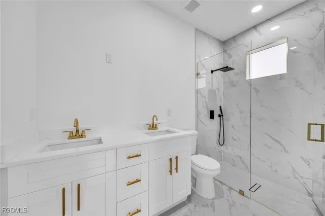 a bathroom with a toilet sink and shower