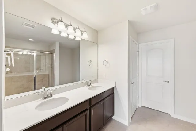 a bathroom with a sink double vanity and a mirror