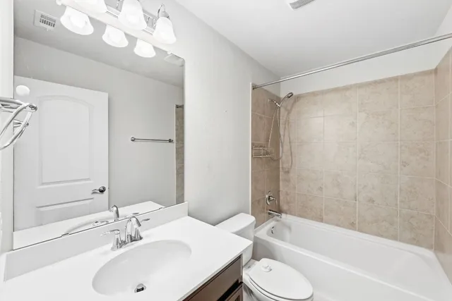 a bathroom with a sink a toilet and bathtub