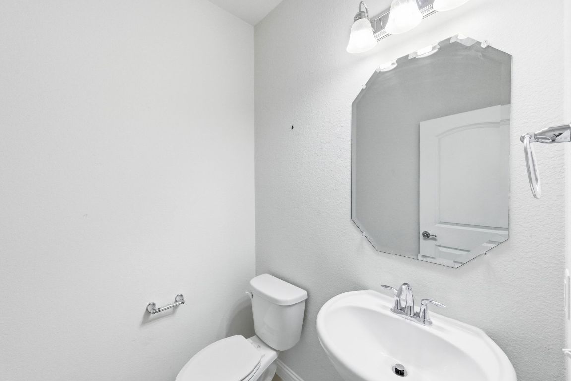 9415 Tanager Way Austin, TX 78748 - Photo 19 of 25 a bathroom with a sink mirror and toilet