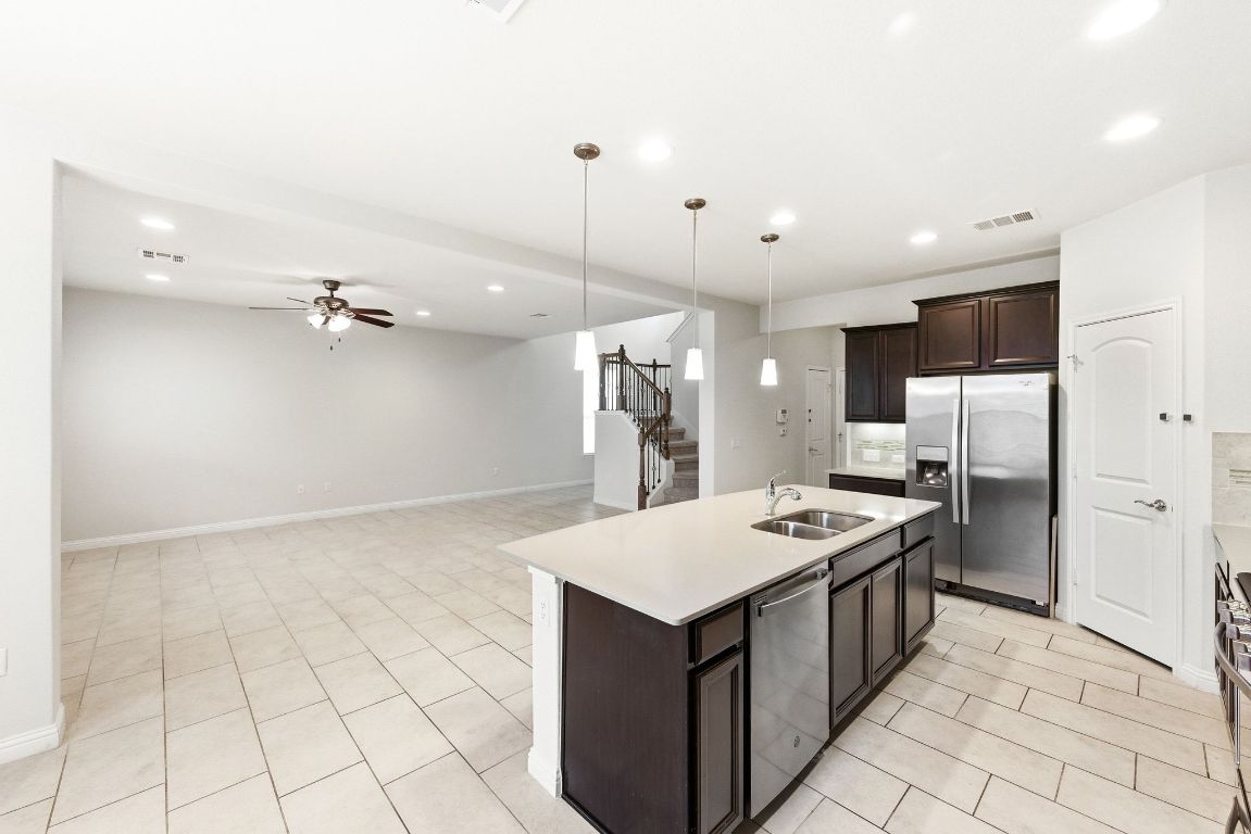 9415 Tanager Way Austin, TX 78748 - Photo 5 of 25 a kitchen that has a lot of cabinets in it