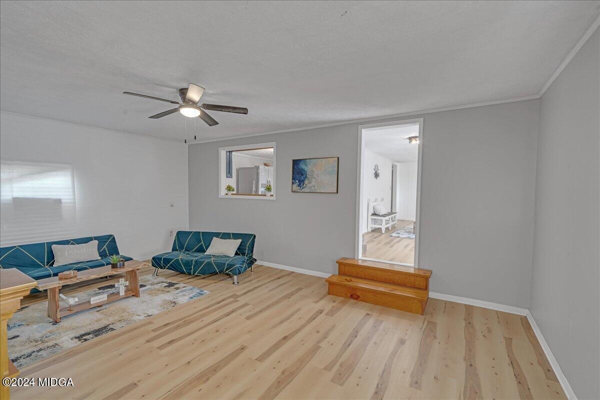 389 Hudson Jones Road Cochran, GA 31014 - Photo 11 of 29 a bedroom with a bed and wooden floor