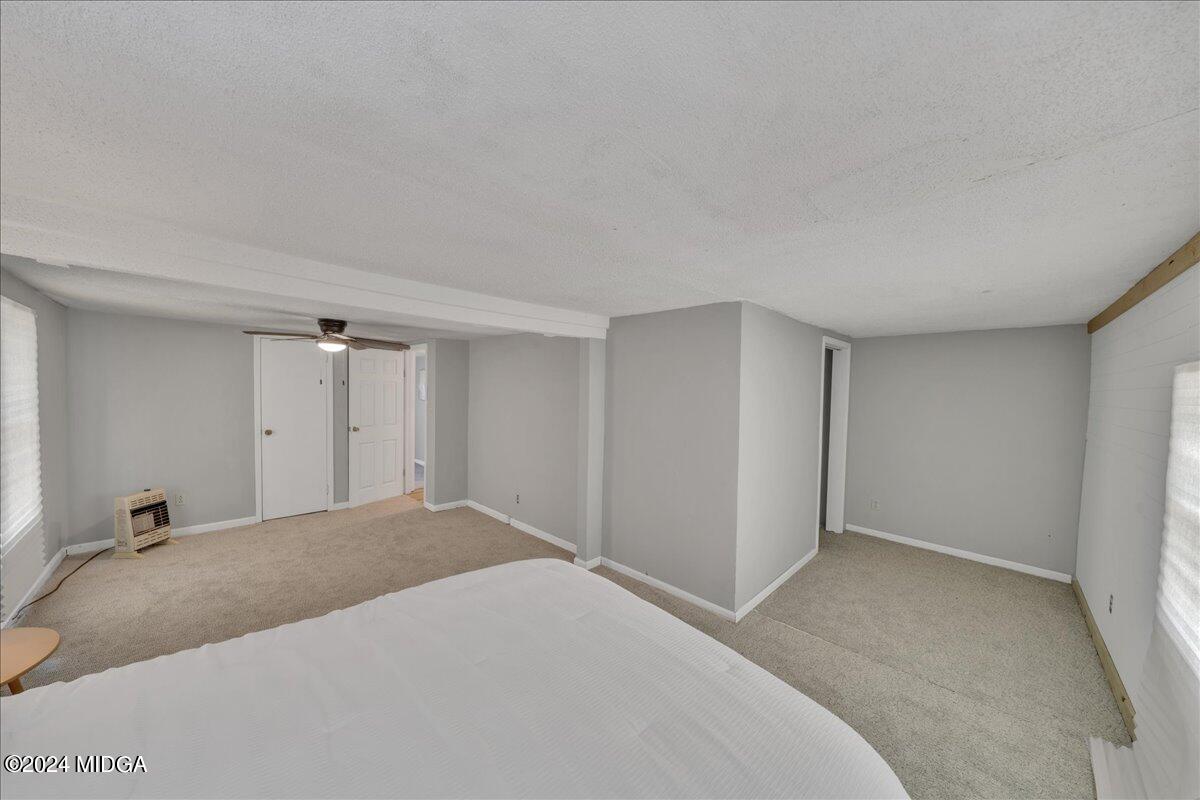 389 Hudson Jones Road Cochran, GA 31014 - Photo 14 of 29 a bedroom with a bed and cabinets