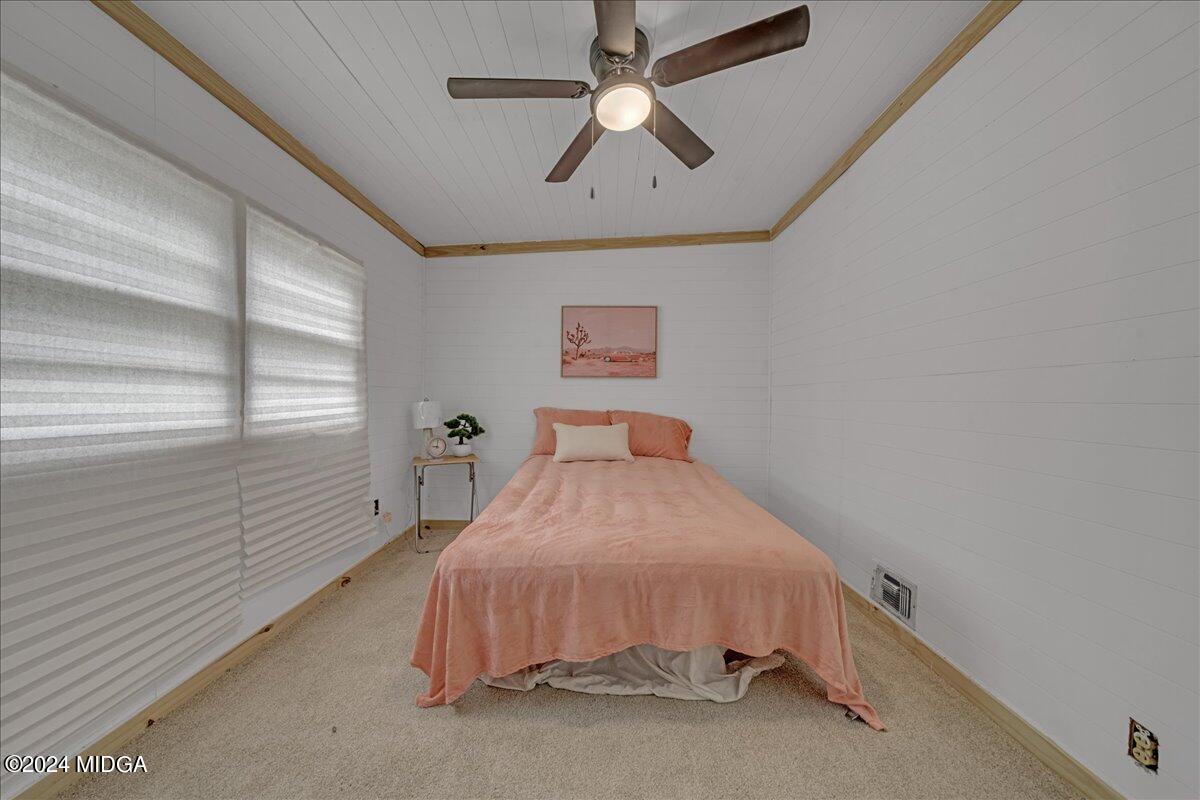389 Hudson Jones Road Cochran, GA 31014 - Photo 20 of 29 a bedroom with a bed and a chandelier
