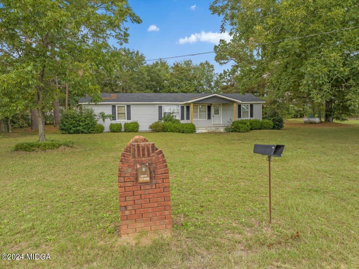 389 Hudson Jones Road Cochran, GA 31014 - Photo 23 of 29 a view of a house with a backyard