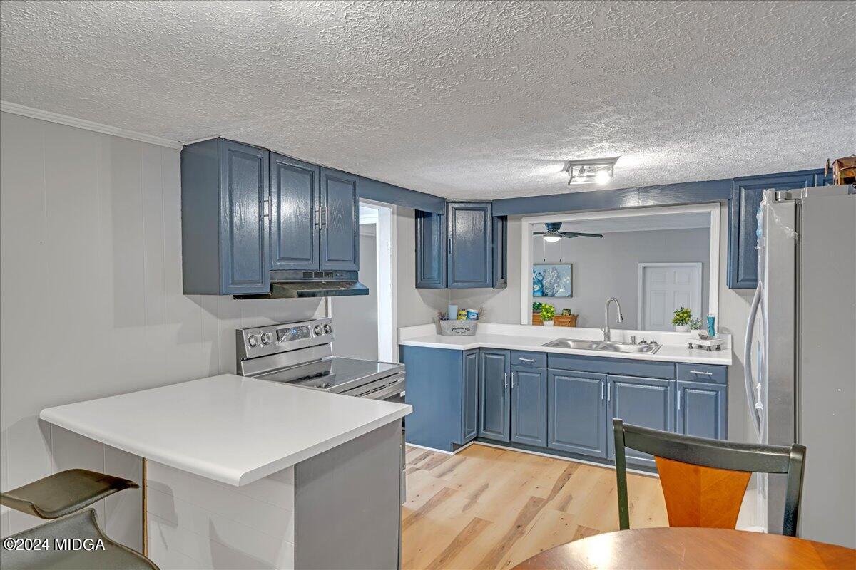 389 Hudson Jones Road Cochran, GA 31014 - Photo 7 of 29 a kitchen with stainless steel appliances a sink counter space and cabinets